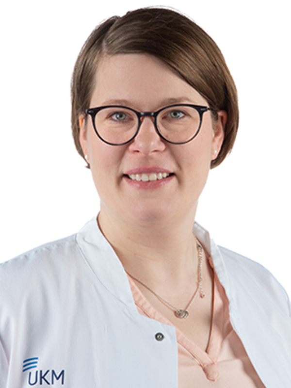 UKM | Portrait einer Mitarbeiterin aus der Angiologie. Sie trägt einen weißen Kittel und lächelt.