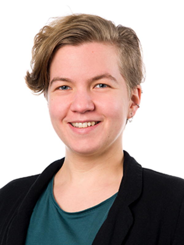 Frau in einem grauen Shirt, die lächelt.