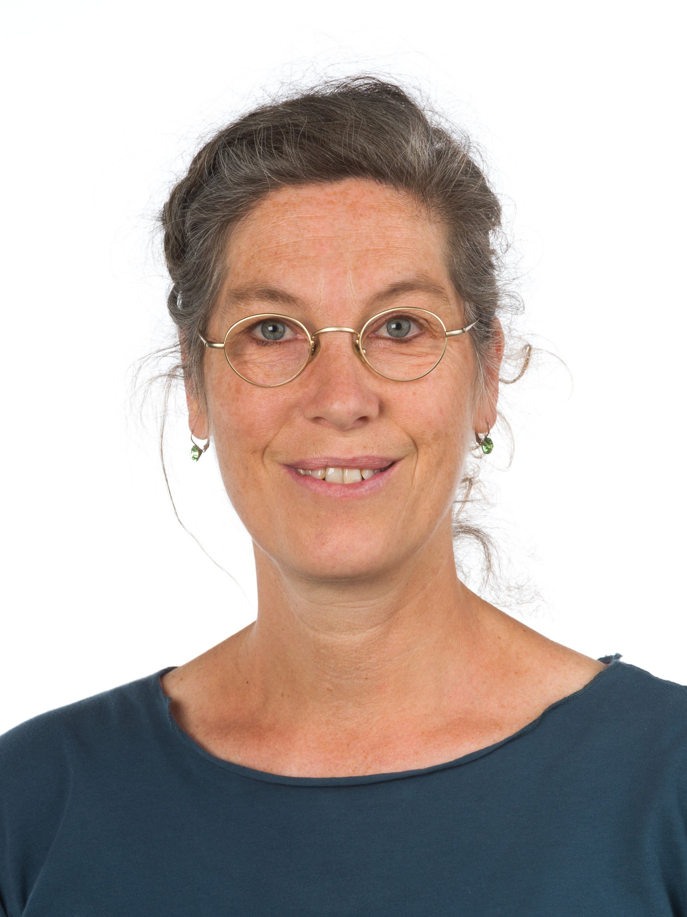 UKM | Portraitfoto einer Kinderkrankenpflegerin. Sie trägt eine Brille und lächelt.