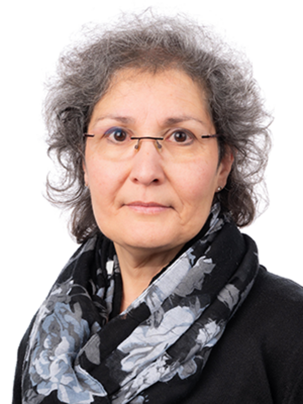 UKM | Portraitfoto einer Mitarbeiterin aus dem Sekretariatsteam der Neurochirurgie. Sie trägt eine Brille und schaut freundlich